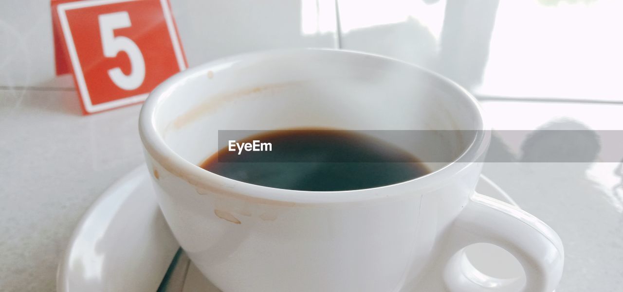 Close-up of coffee cup on table