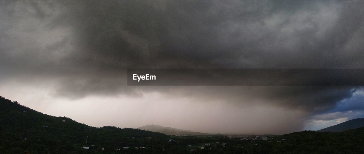 SCENIC VIEW OF MOUNTAIN AGAINST CLOUDY SKY