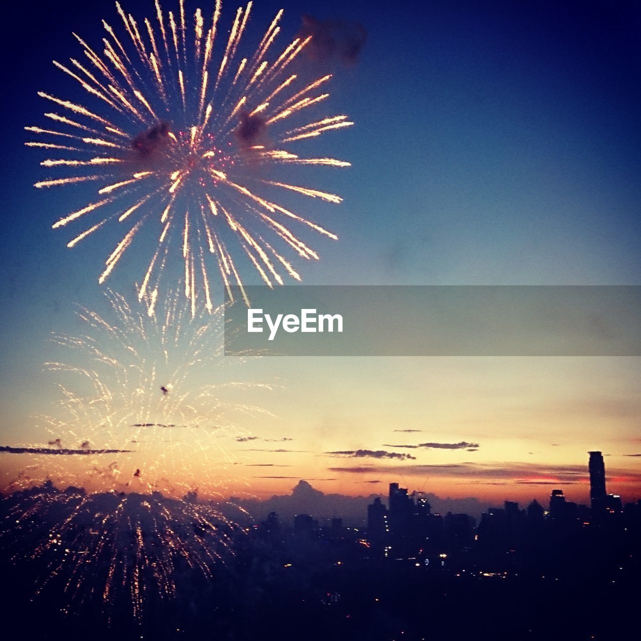 Fireworks display in sky during sunset