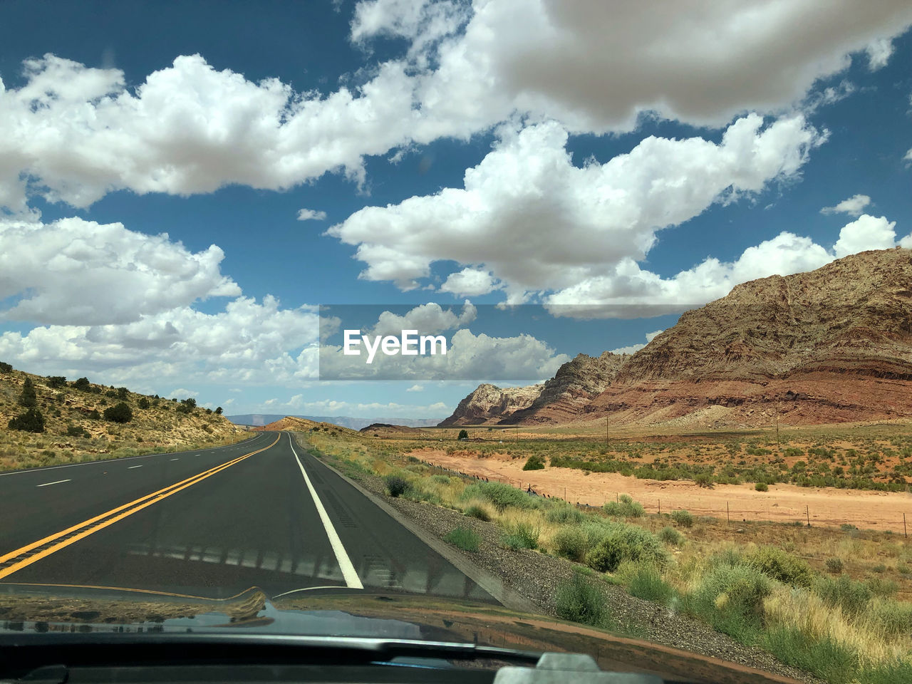 PANORAMIC VIEW OF ROAD SEEN THROUGH WINDSHIELD