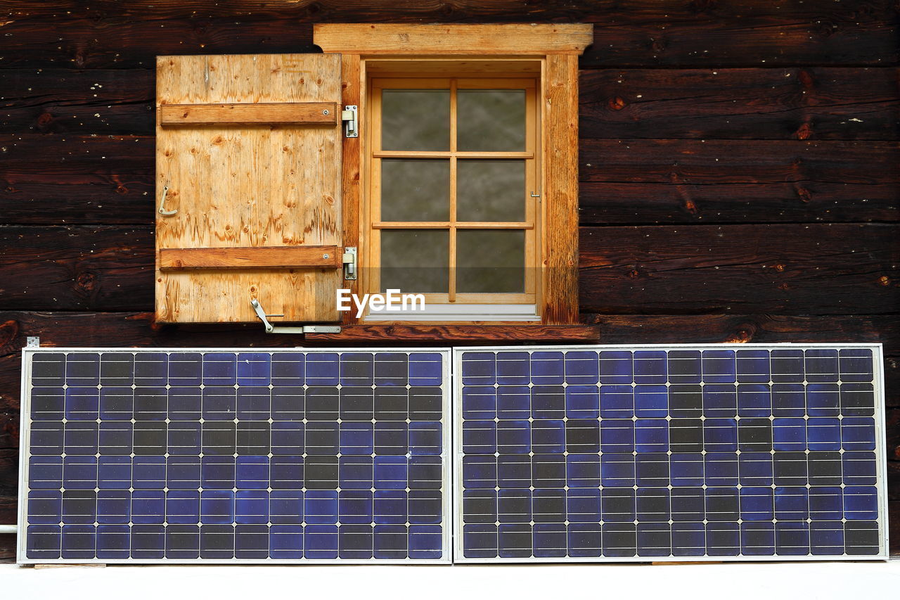 Solar panels on log cabin wall