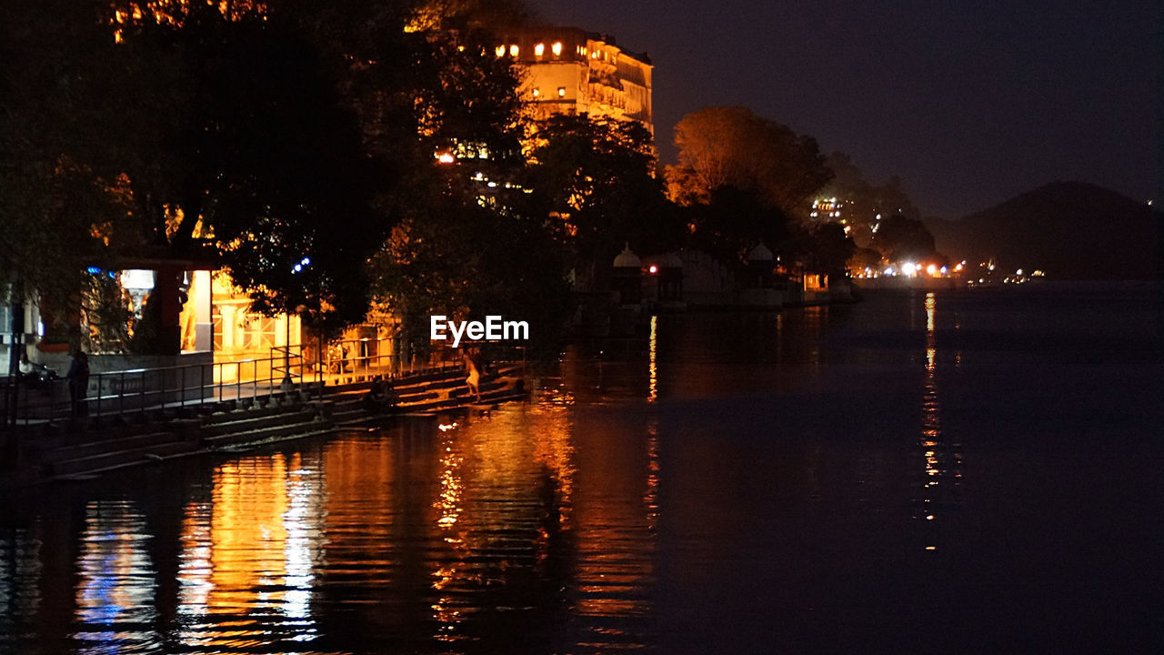 VIEW OF ILLUMINATED CITY AT NIGHT