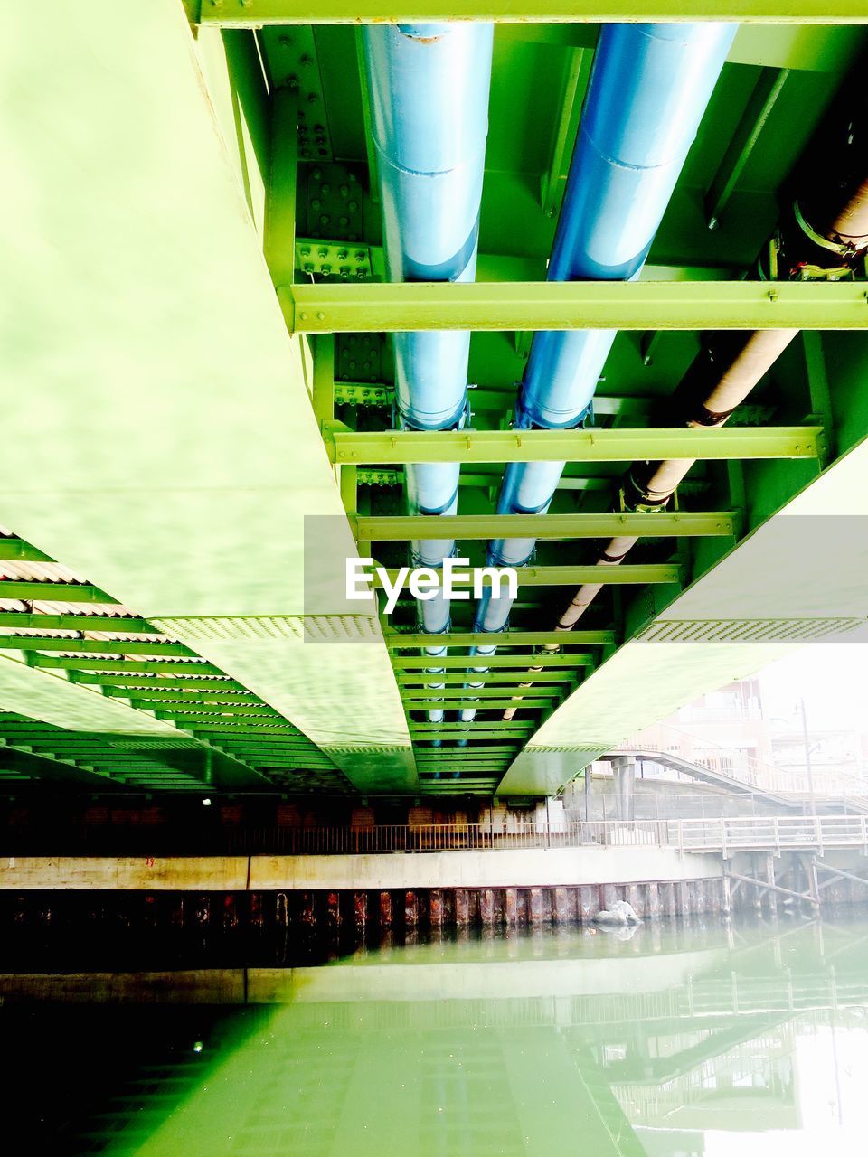 Low angle view of bridge over calm water