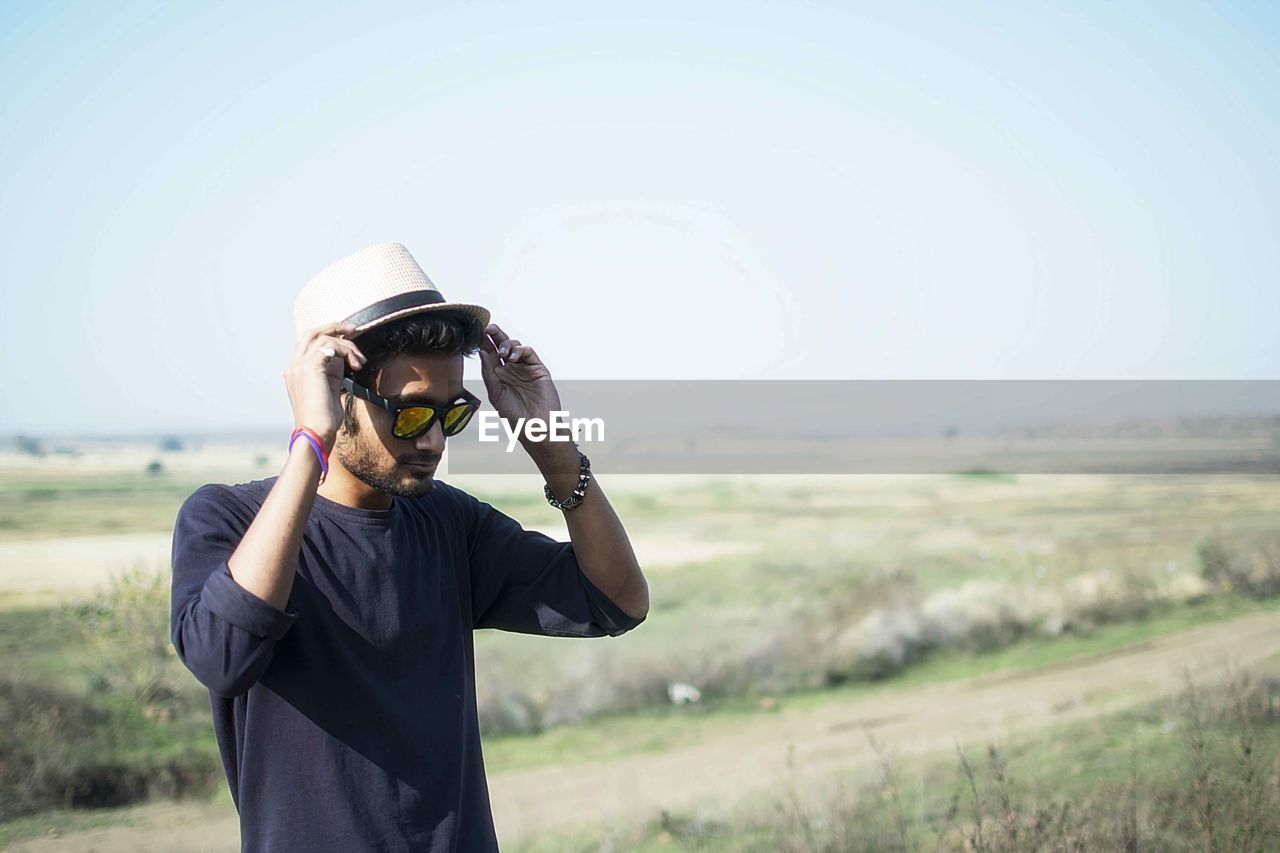 Young man standing on field