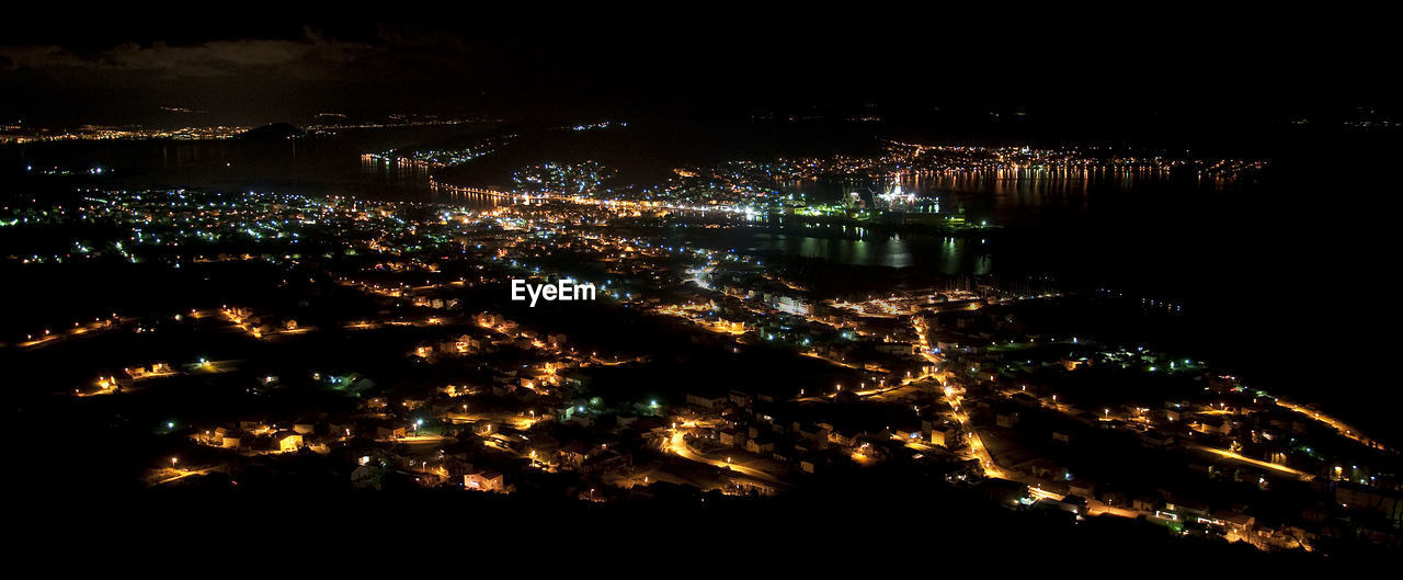 High angle view of illuminated buildings in city at night