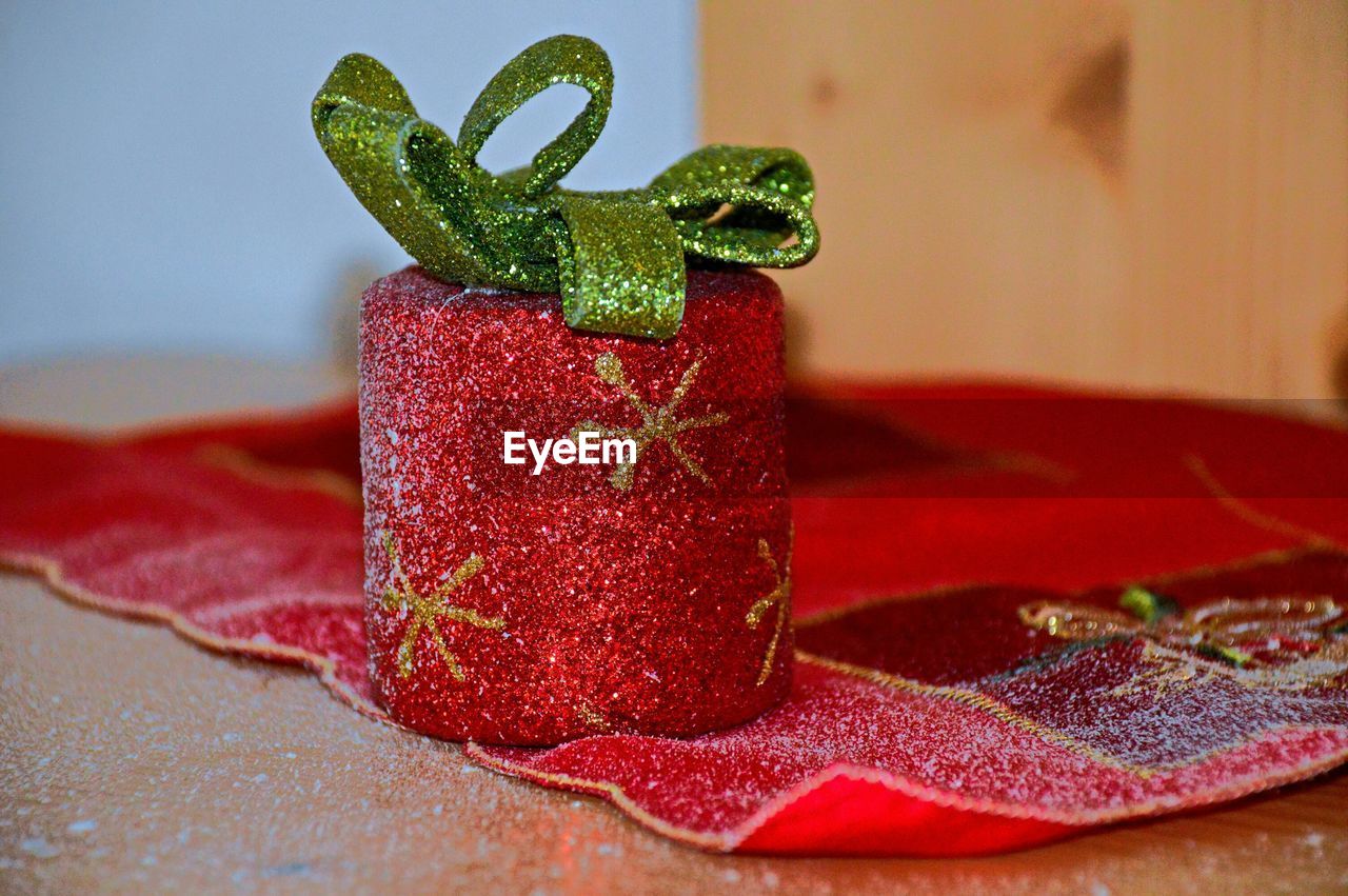 Close-up of red christmas decoration on table