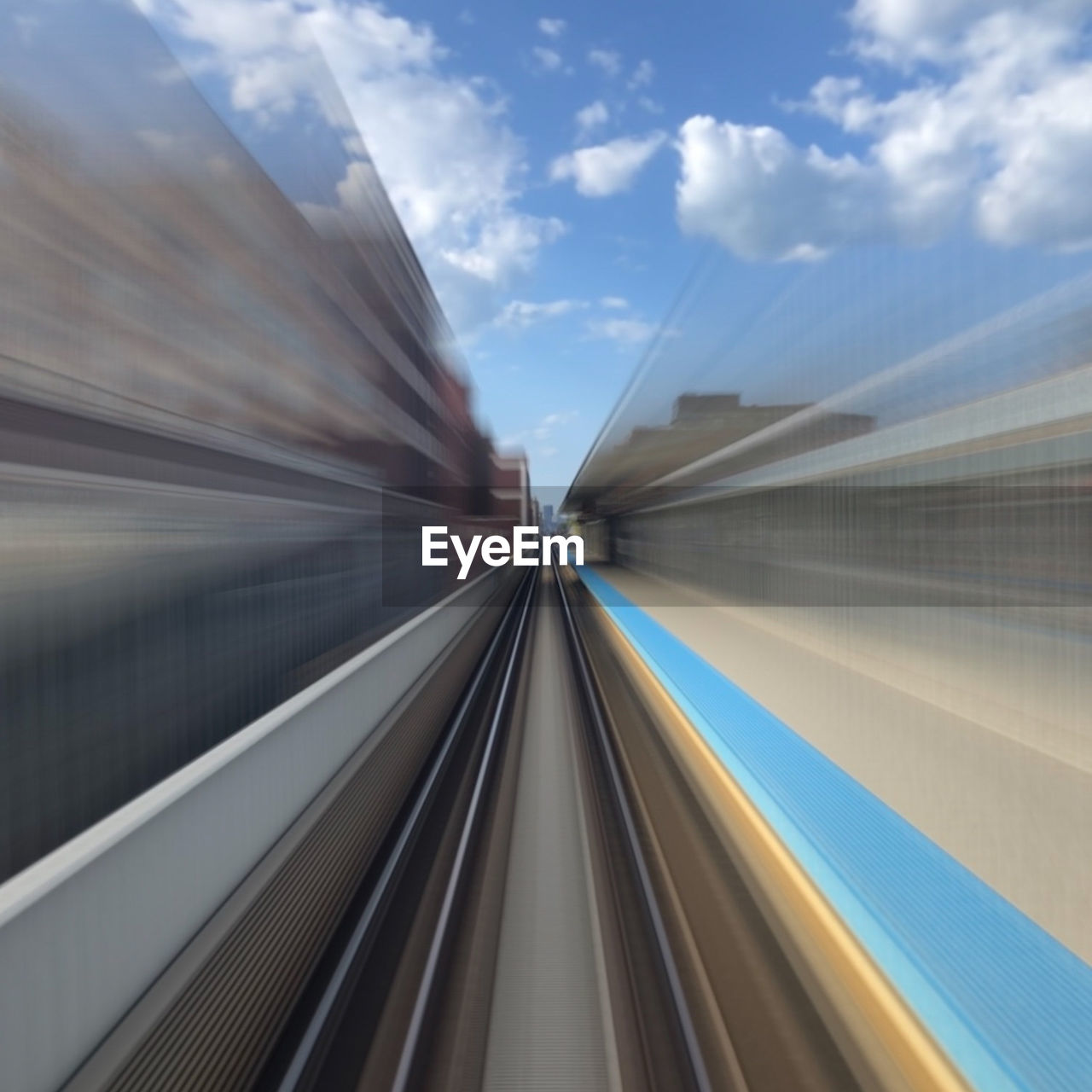 BLURRED MOTION OF TRAIN MOVING ON RAILROAD TRACK