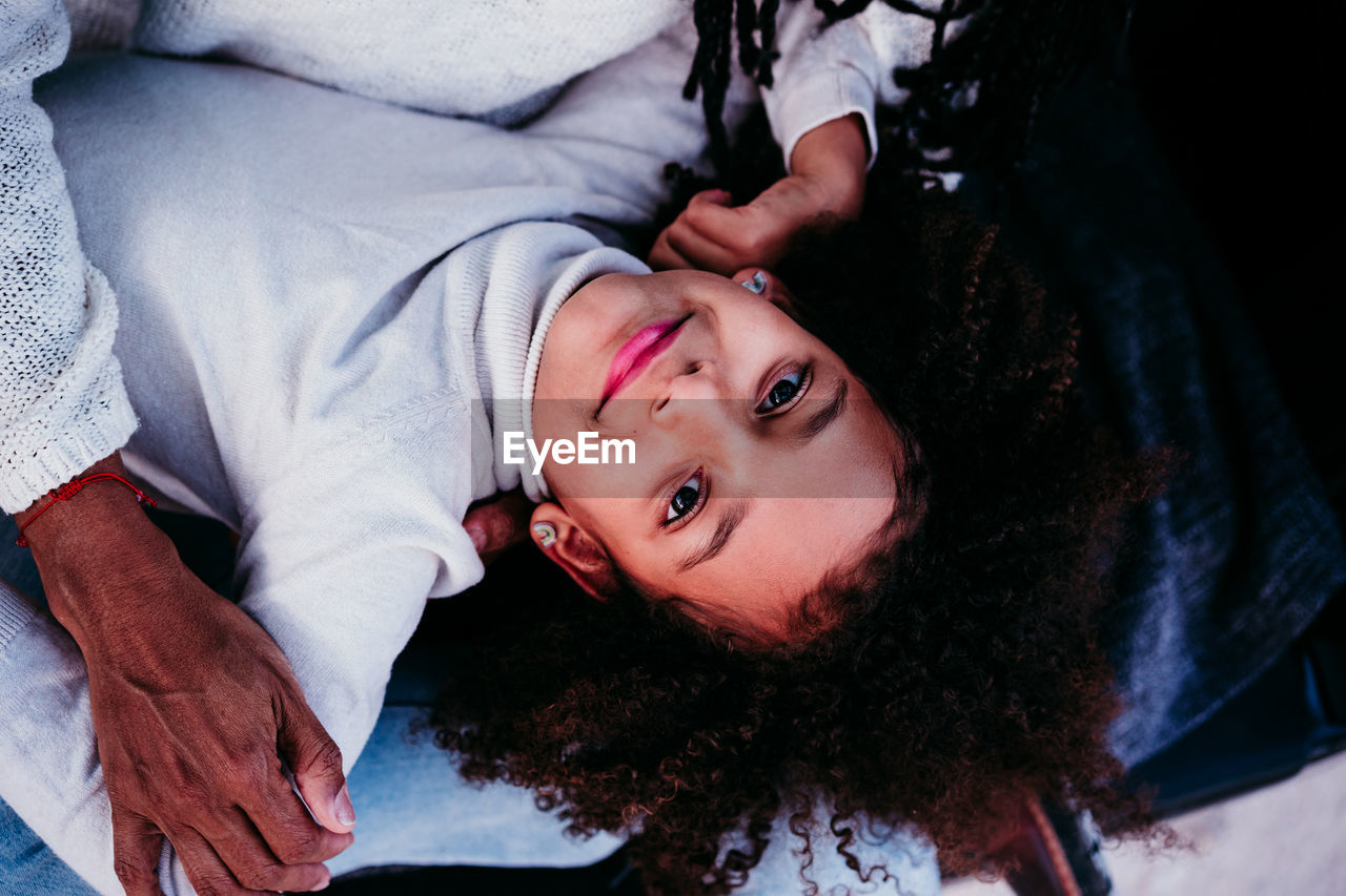 High angle portrait of boy lying on bed