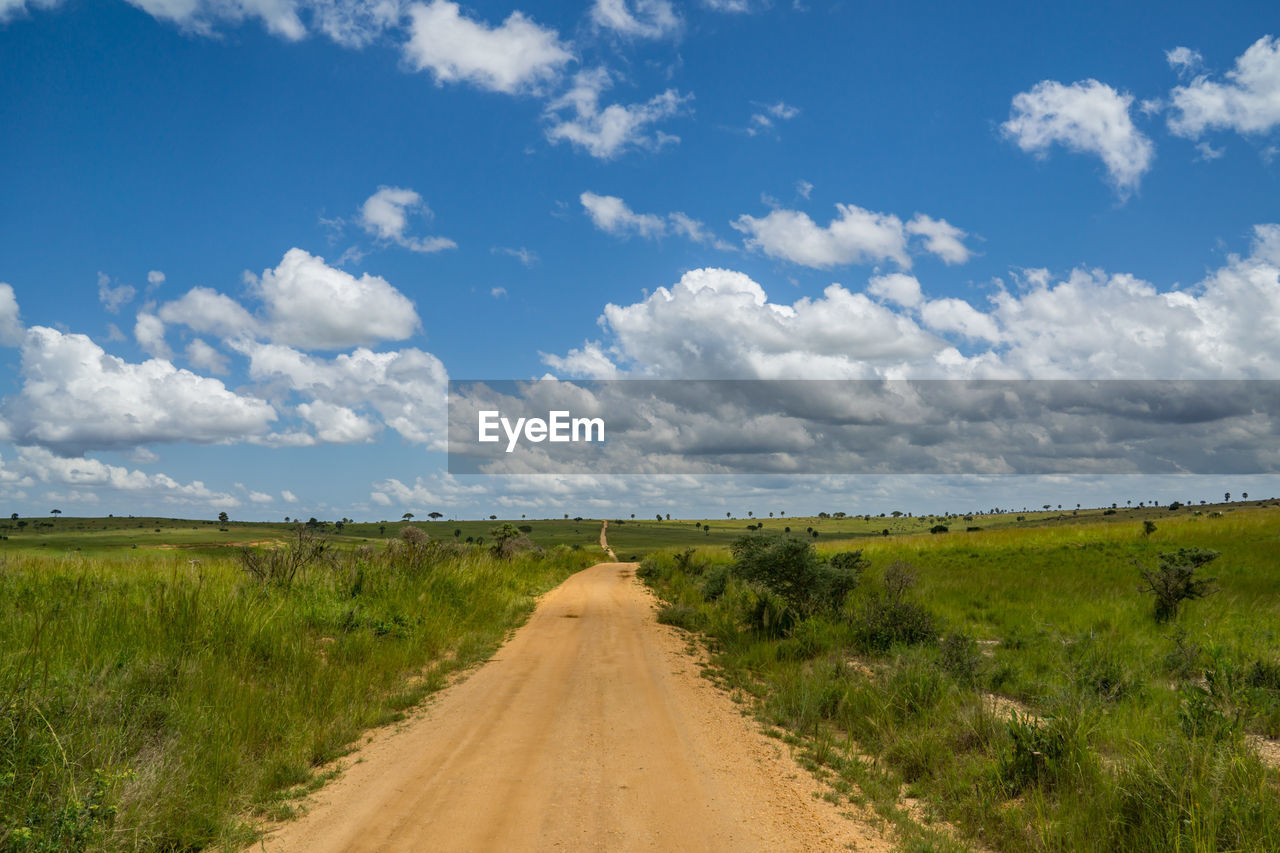 Dirt road along countryside landscape