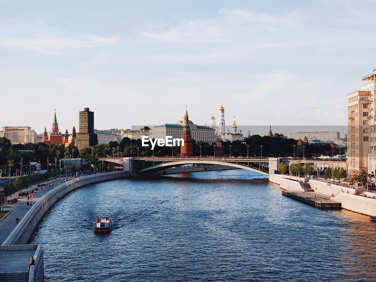 Bridge over river in city against sky