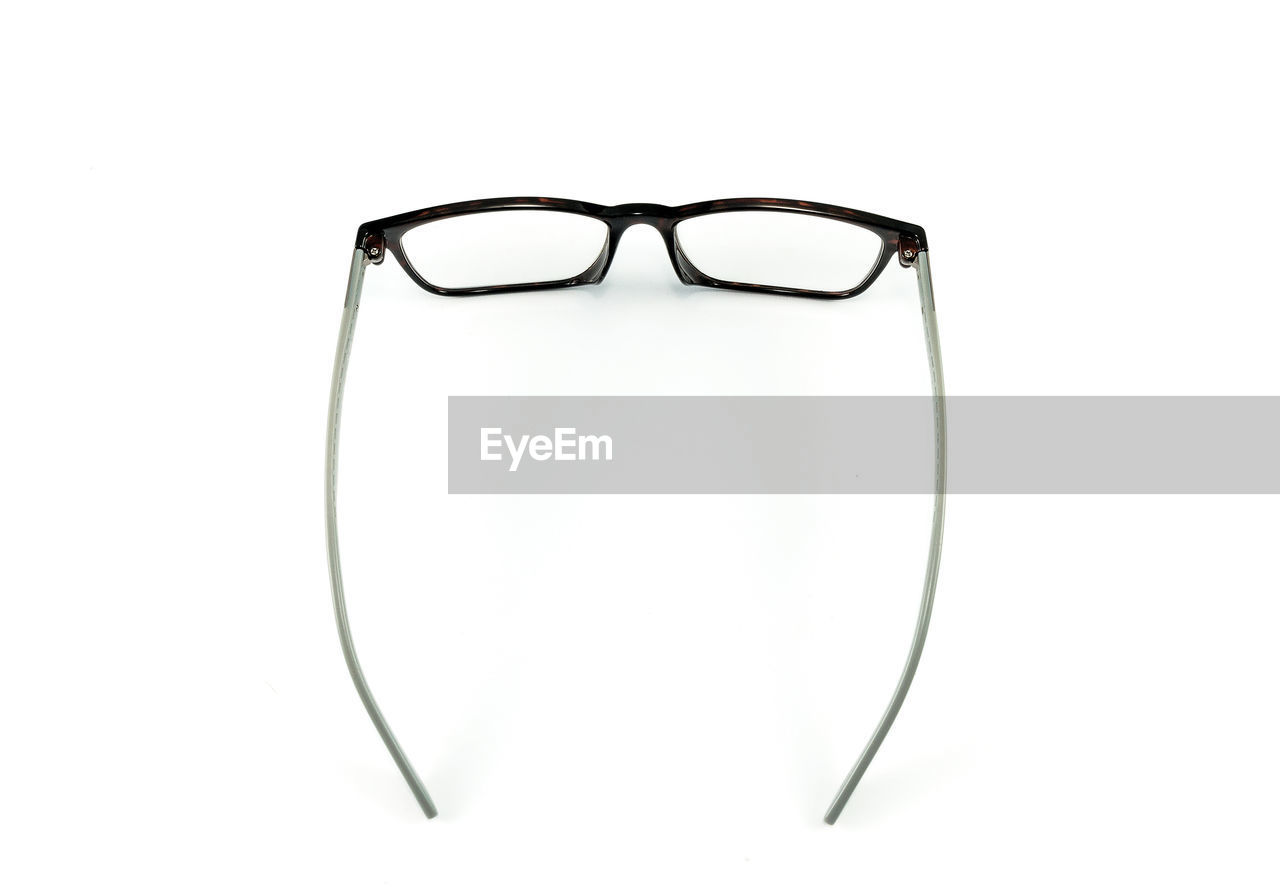 Close-up of eyeglasses over white background