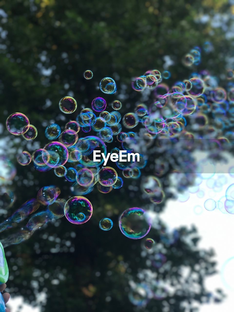 CLOSE-UP OF BUBBLES AGAINST RAINBOW