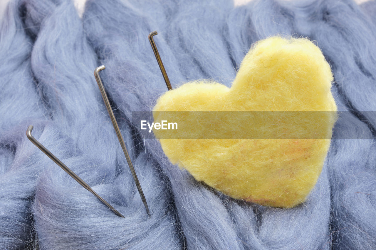 CLOSE-UP OF HEART SHAPE MADE OF YELLOW AND PAPER