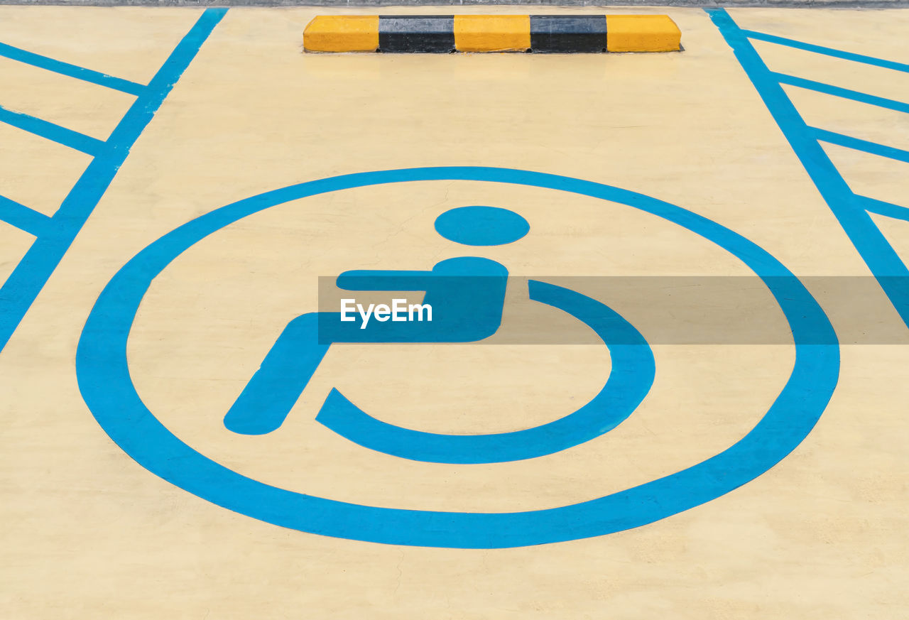Parking signs for the disabled on the parking lot floor, disability sign in car park