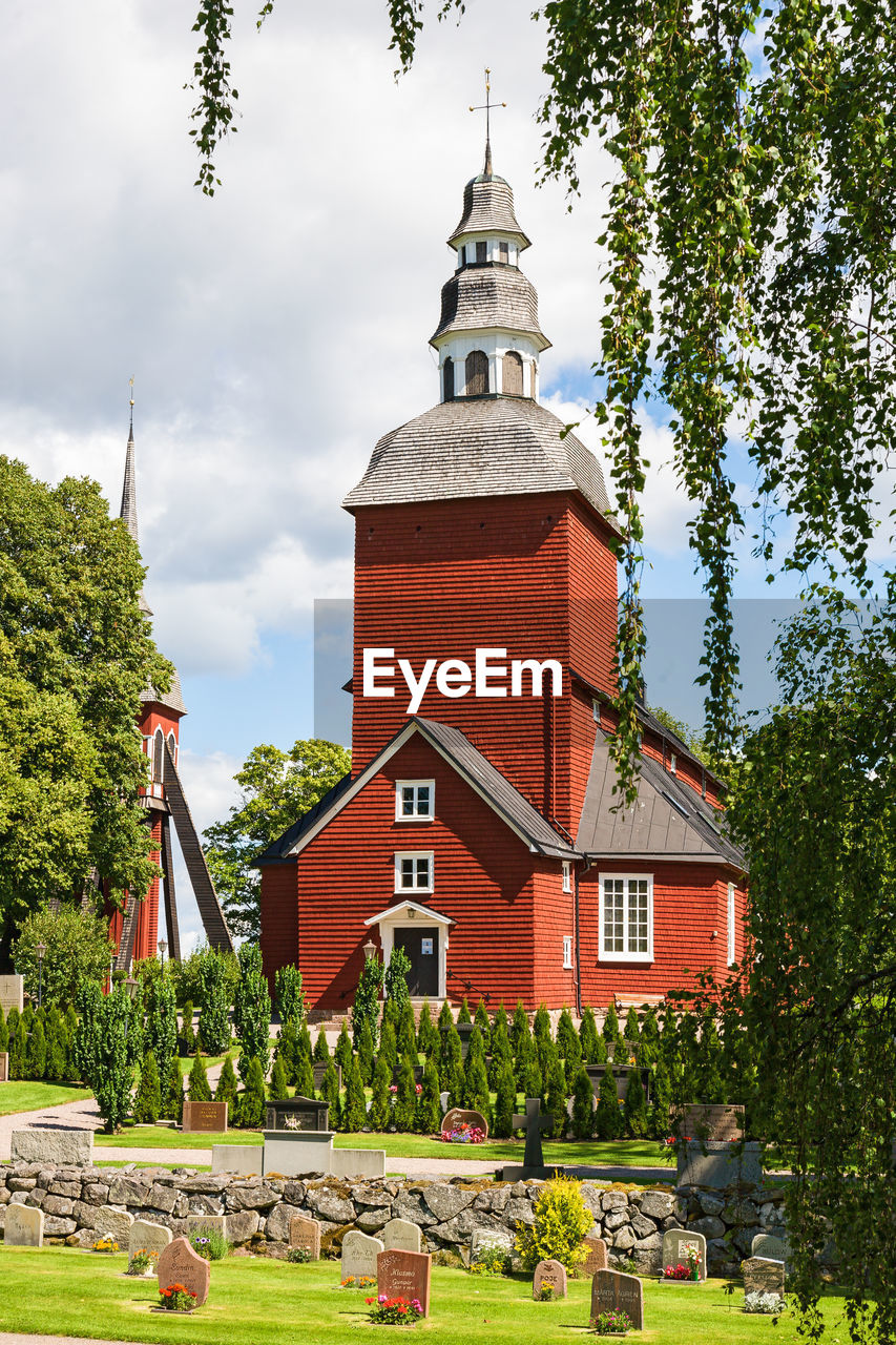 Red rural wooden church in summer