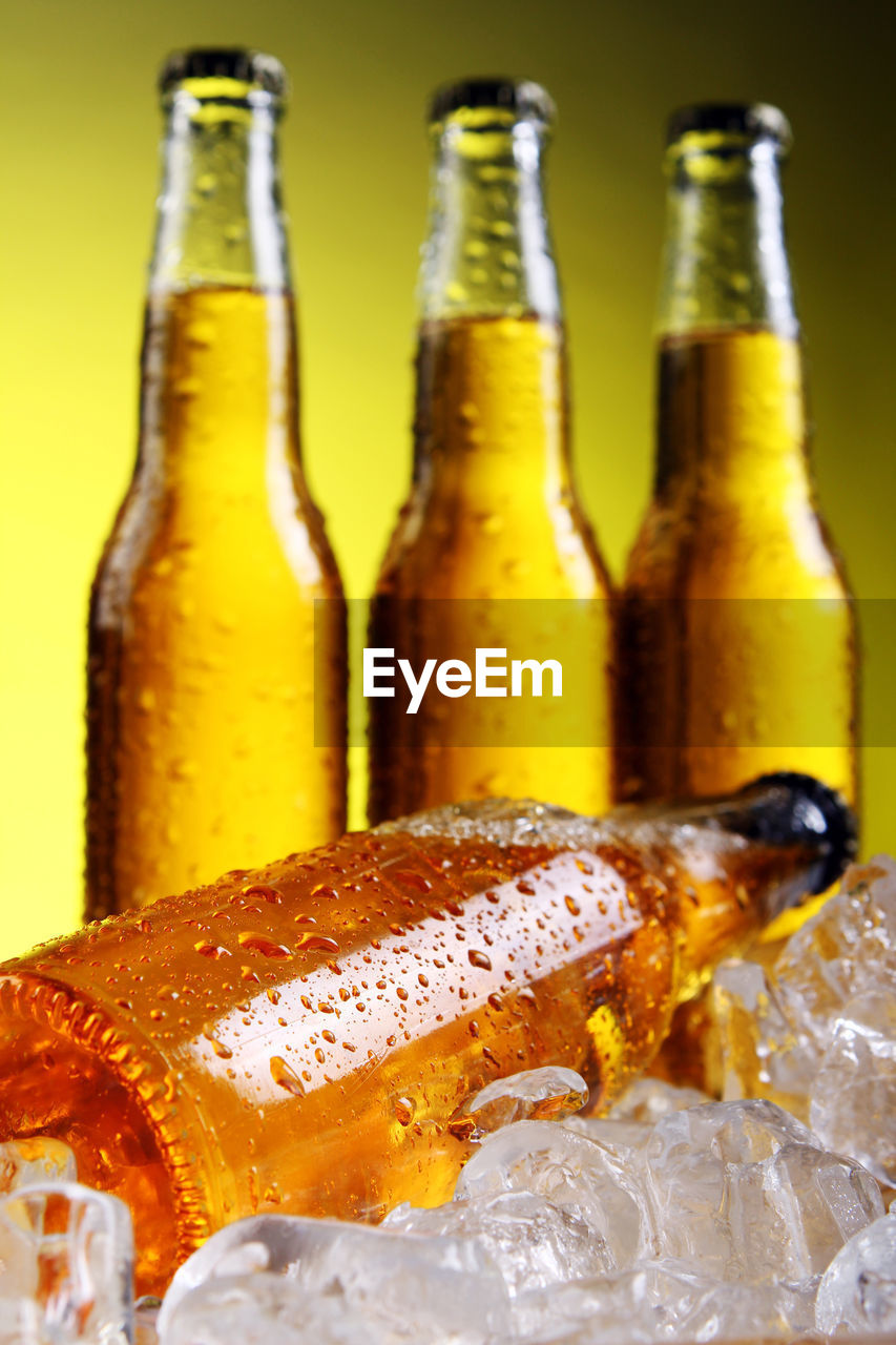 Close-up of beer bottles on ice cubes