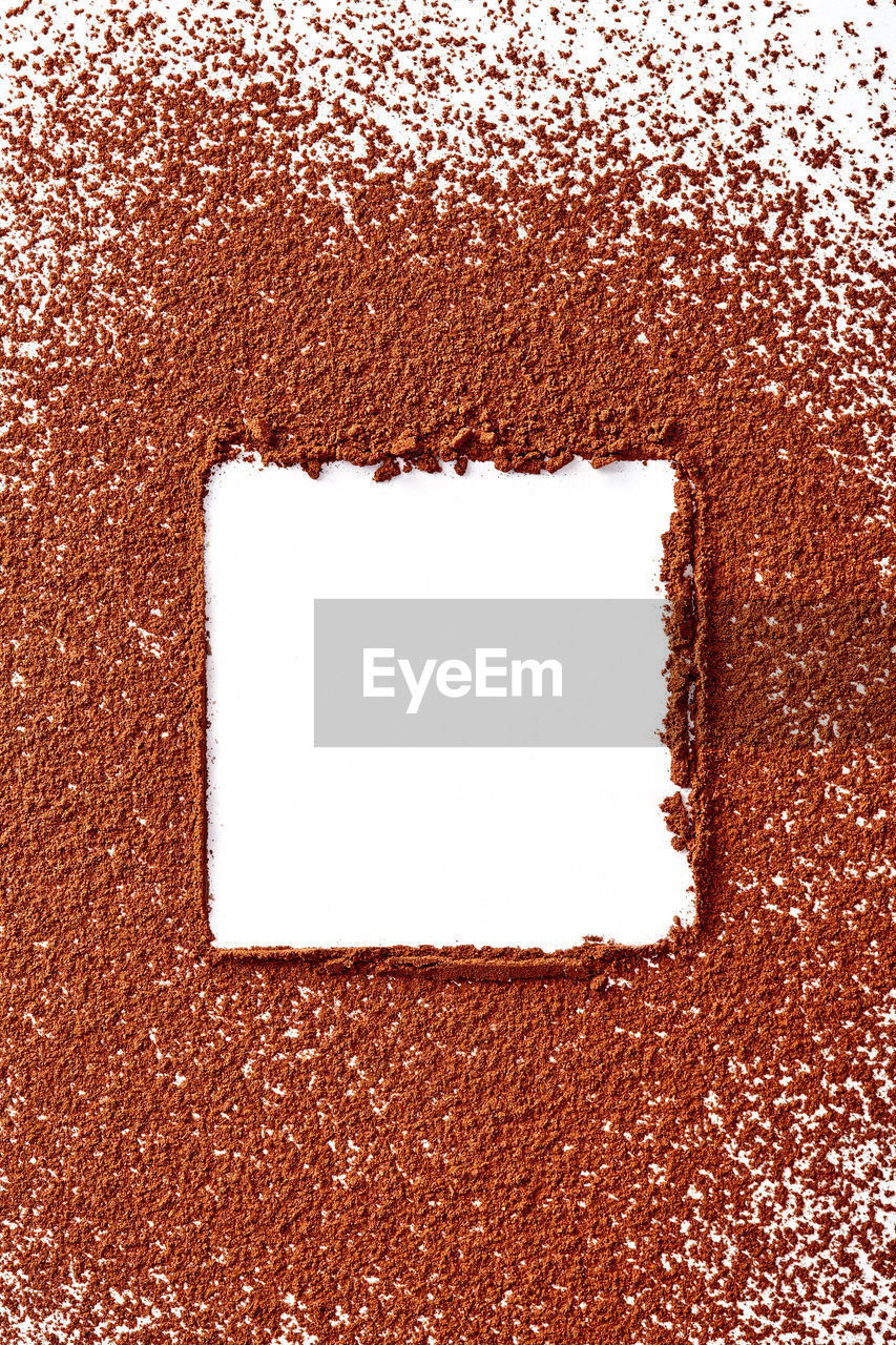 Close-up of cocoa powder against white background