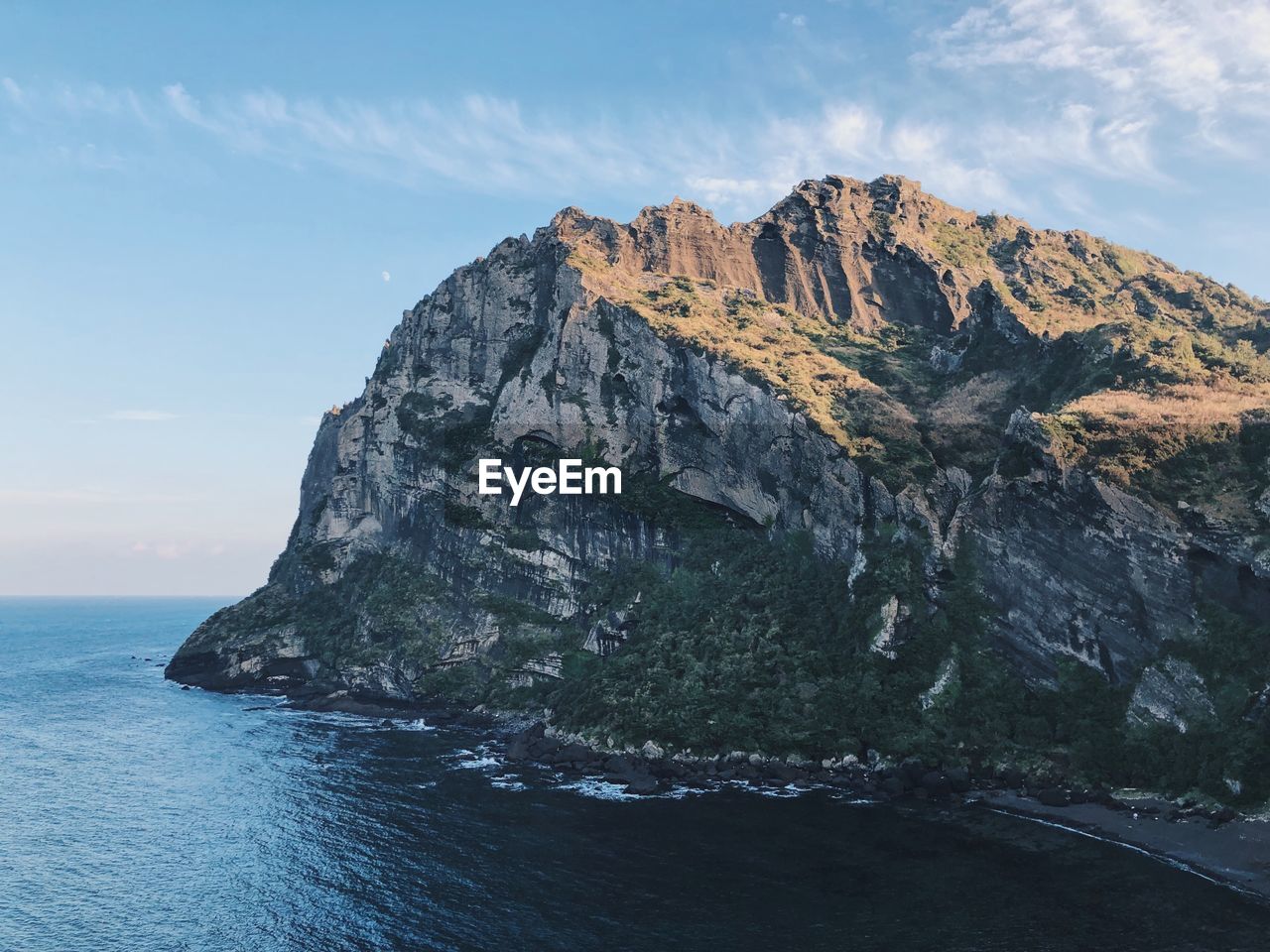 Rock formations by sea against sky