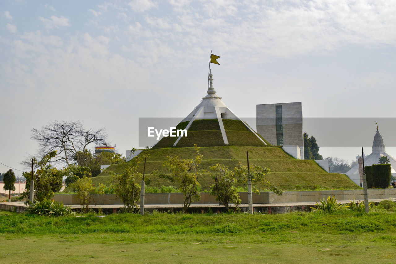 architecture, built structure, building exterior, sky, religion, building, belief, place of worship, nature, travel destinations, history, rural area, plant, the past, cloud, spirituality, landscape, travel, landmark, no people, grass, environment, tourism, tower, outdoors, day, temple - building, city, tree, spire