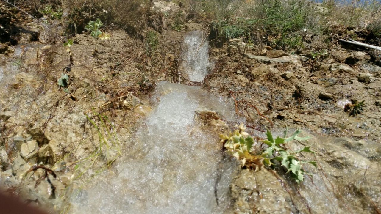 WATER FLOWING AMIDST ROCKS