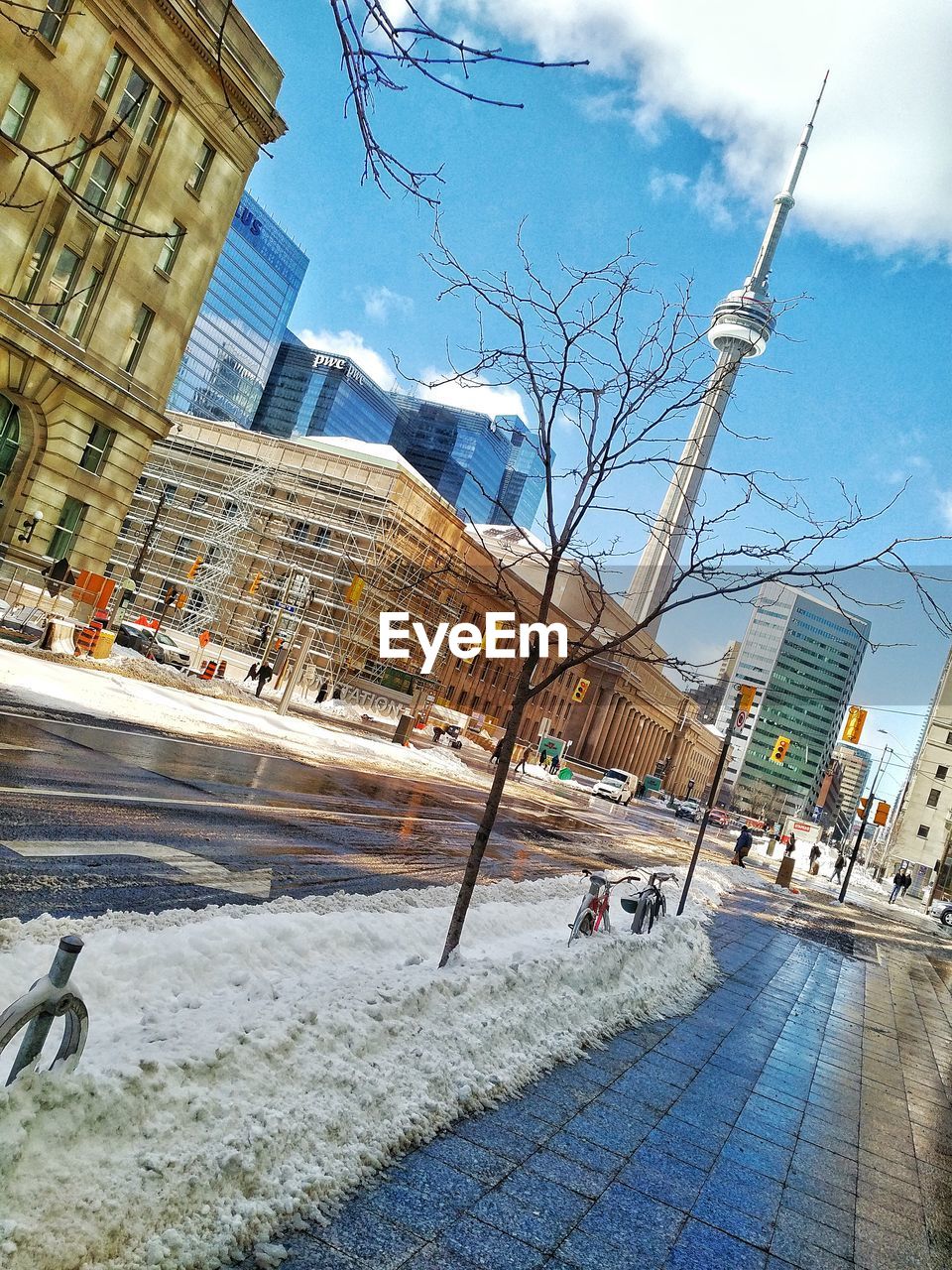 Road against cn tower amidst buildings in city during winter