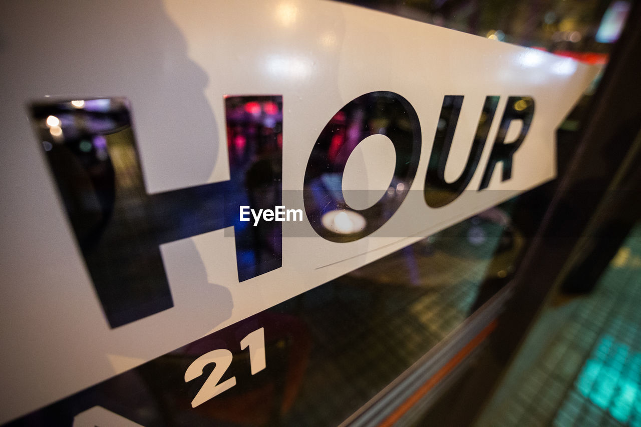 CLOSE-UP OF TEXT ON GLASS AT HOME