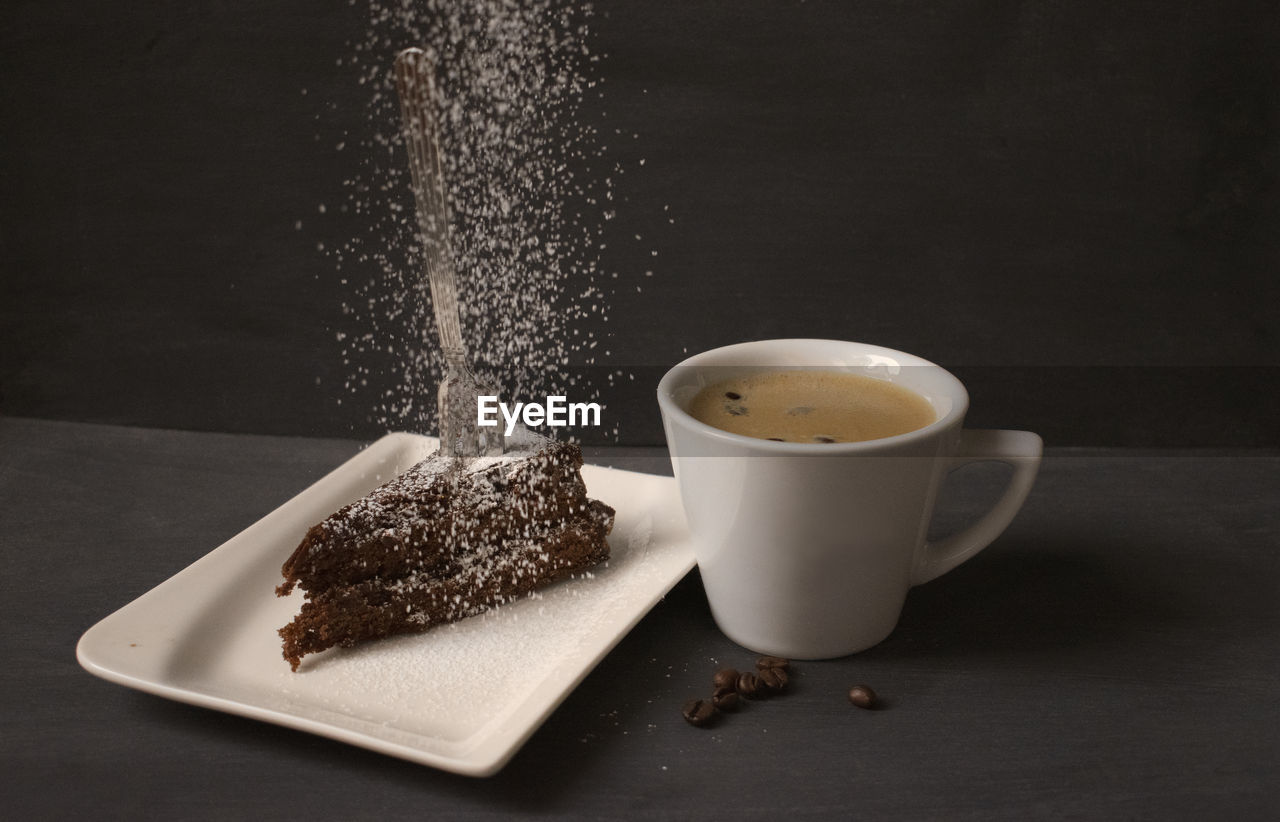 CLOSE-UP OF CHOCOLATE CAKE AND COFFEE