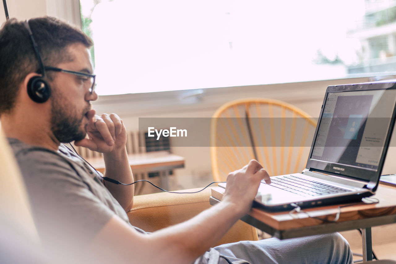 Young man using laptop at home