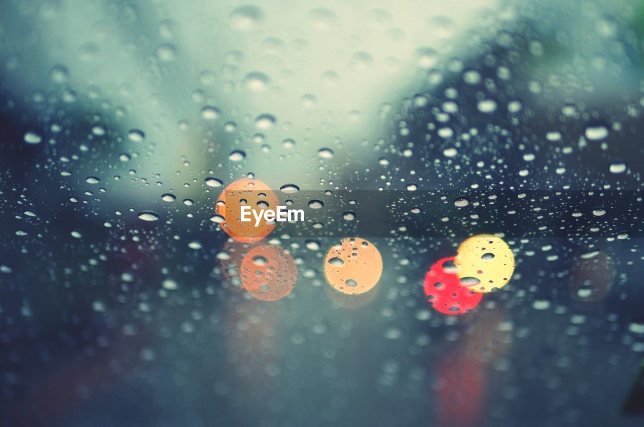 CLOSE-UP OF WET WINDOW IN RAINY SEASON