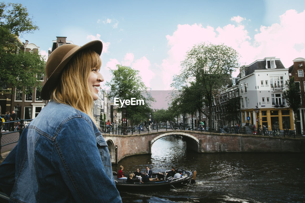 Smiling woman overlooking canal and city