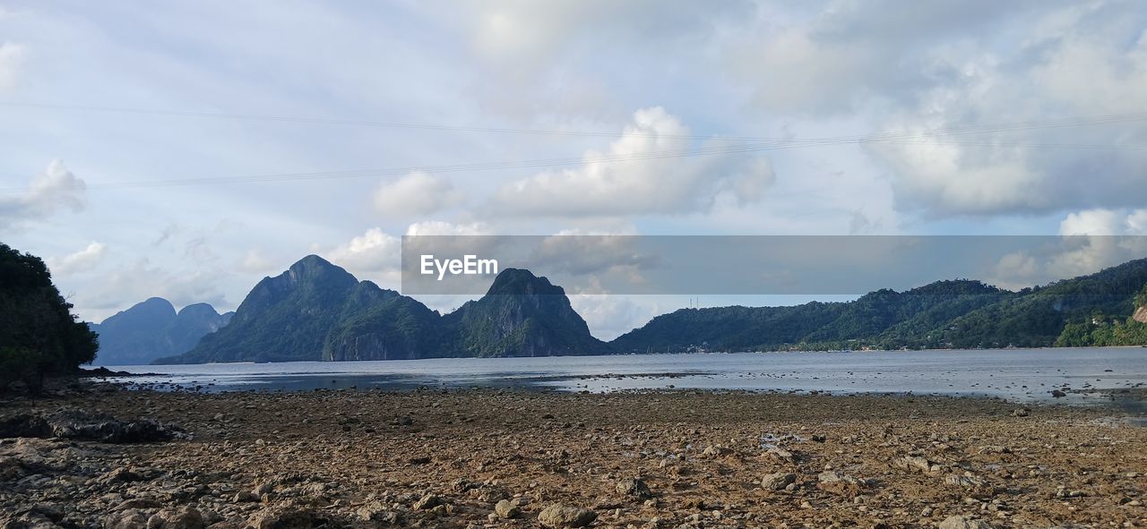 mountain, sky, cloud, water, scenics - nature, land, sea, environment, beauty in nature, nature, landscape, coast, body of water, shore, beach, horizon, mountain range, travel destinations, panoramic, no people, travel, bay, tranquility, tranquil scene, ocean, rock, day, outdoors, non-urban scene, tourism