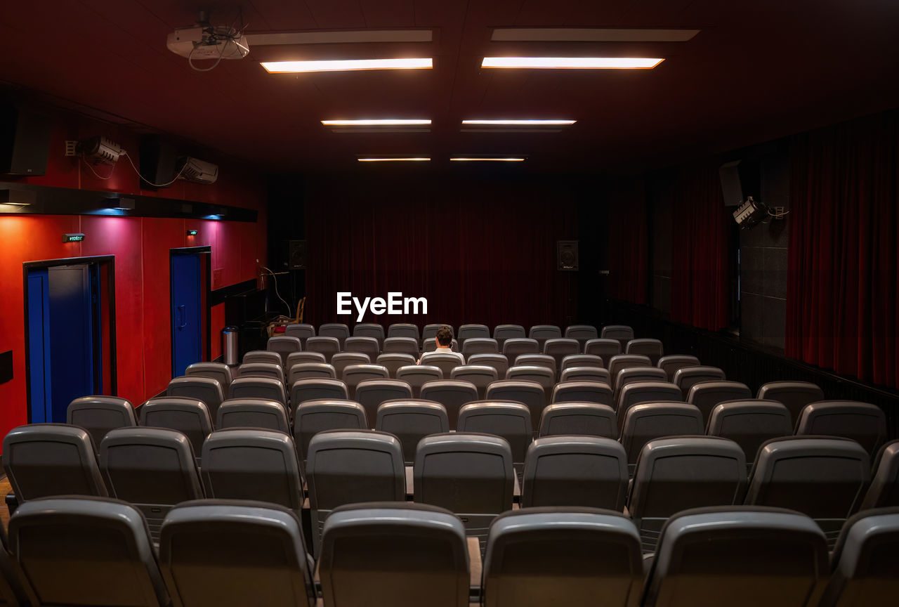 auditorium, seat, indoors, arts culture and entertainment, in a row, movie theater, chair, stage theater, theatre, no people, function hall, conference hall, empty, stage, absence, red, architecture, film industry