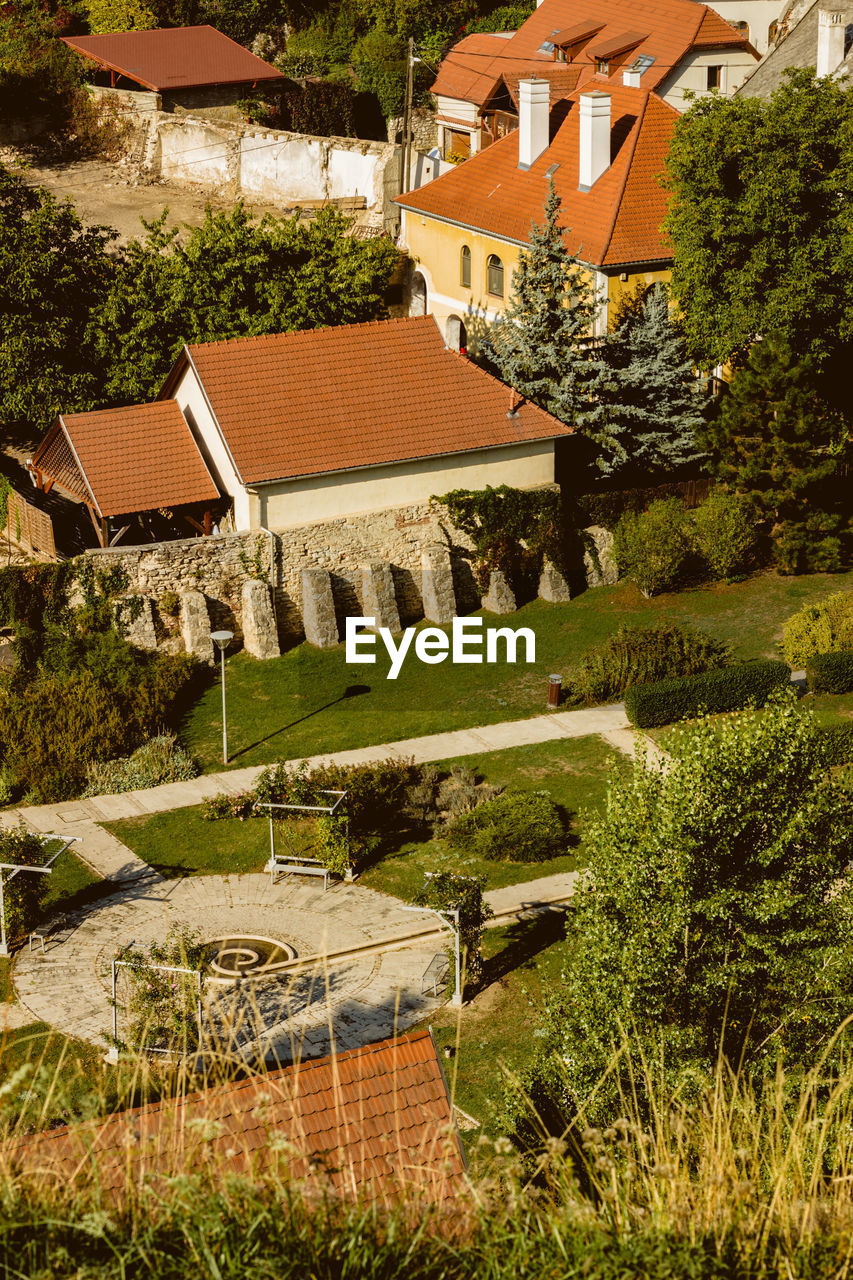 HIGH ANGLE VIEW OF HOUSES AND TREES BY HOUSE