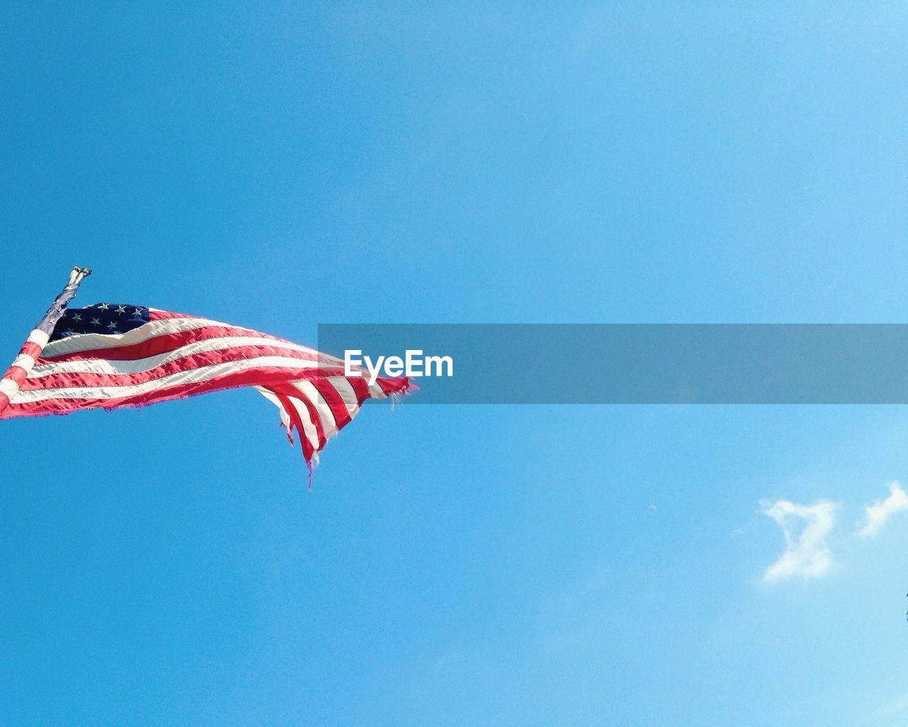 Low angle view of american flag against sky