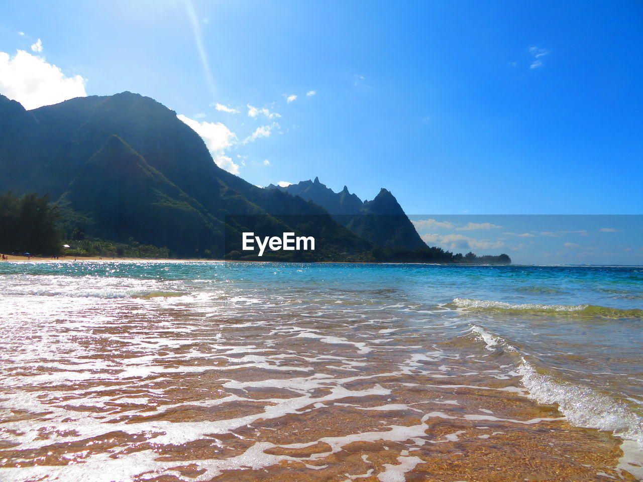 water, land, sea, sky, scenics - nature, beach, beauty in nature, body of water, nature, mountain, travel destinations, ocean, environment, shore, travel, landscape, tranquility, cloud, coast, blue, tranquil scene, wave, holiday, trip, vacation, sand, tourism, bay, idyllic, coastline, no people, outdoors, wind wave, island, summer, sunlight, horizon, water sports, sports, tropical climate, day, motion, seascape, bay of water, sunny, sun, non-urban scene, rock, lagoon, mountain range, water's edge, tree
