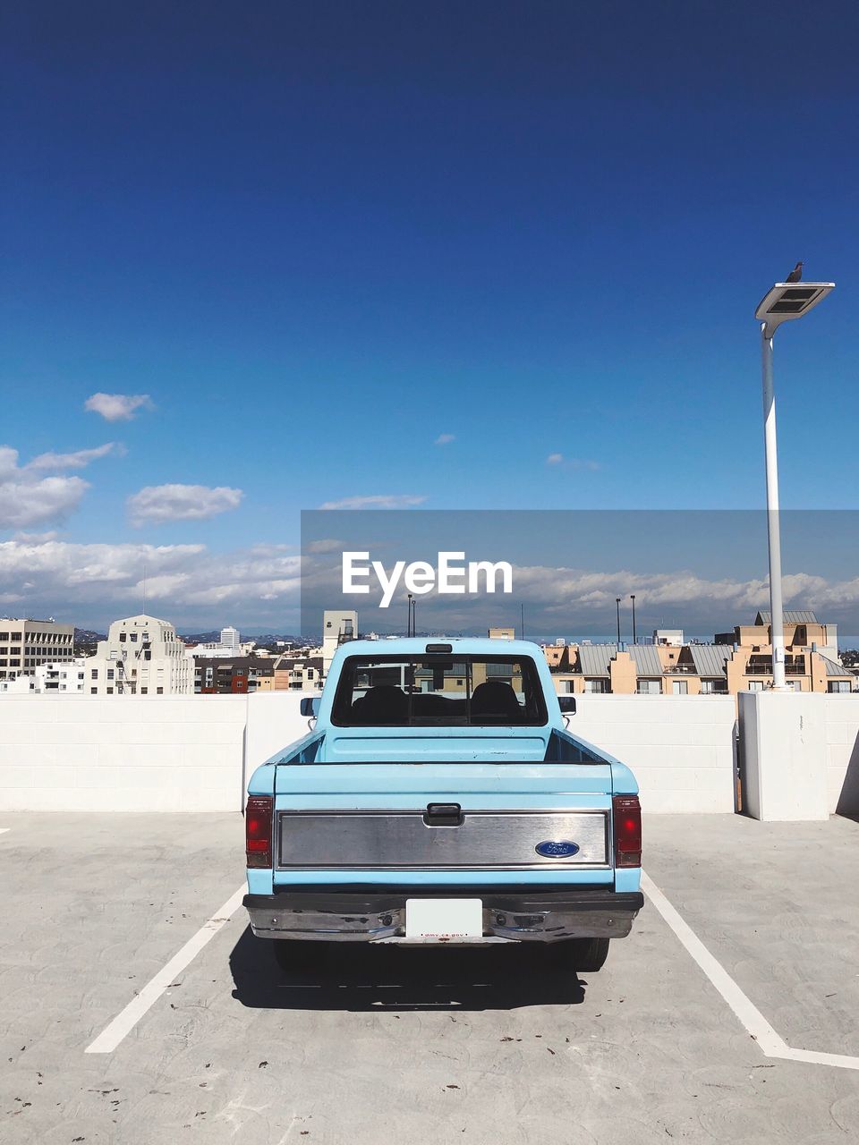 CARS ON ROAD AGAINST BLUE SKY