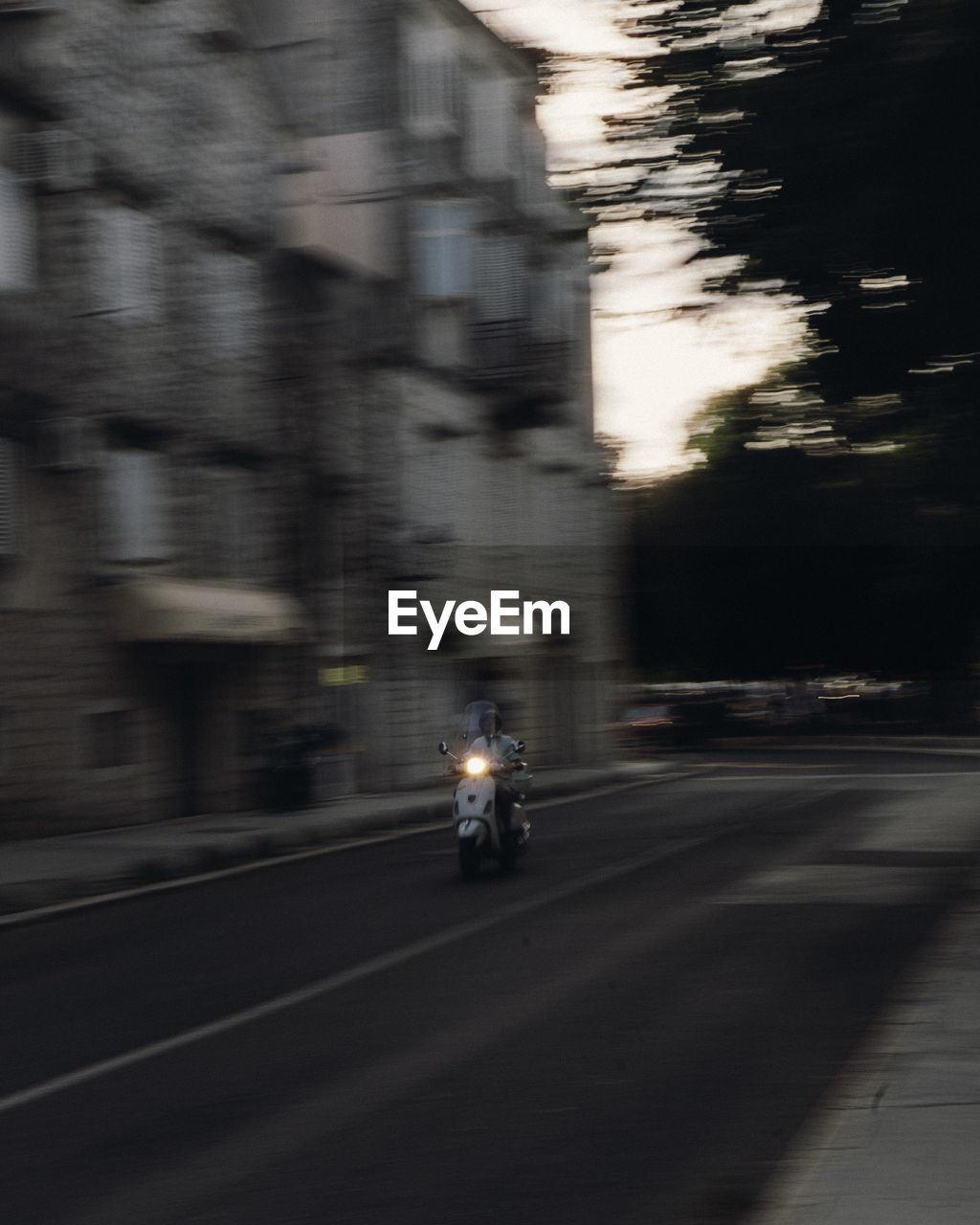 blurred motion of man walking on road