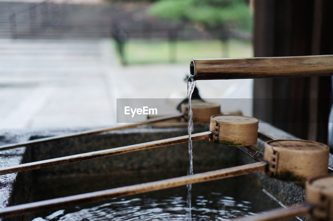 Close-up of wooden ladles by water