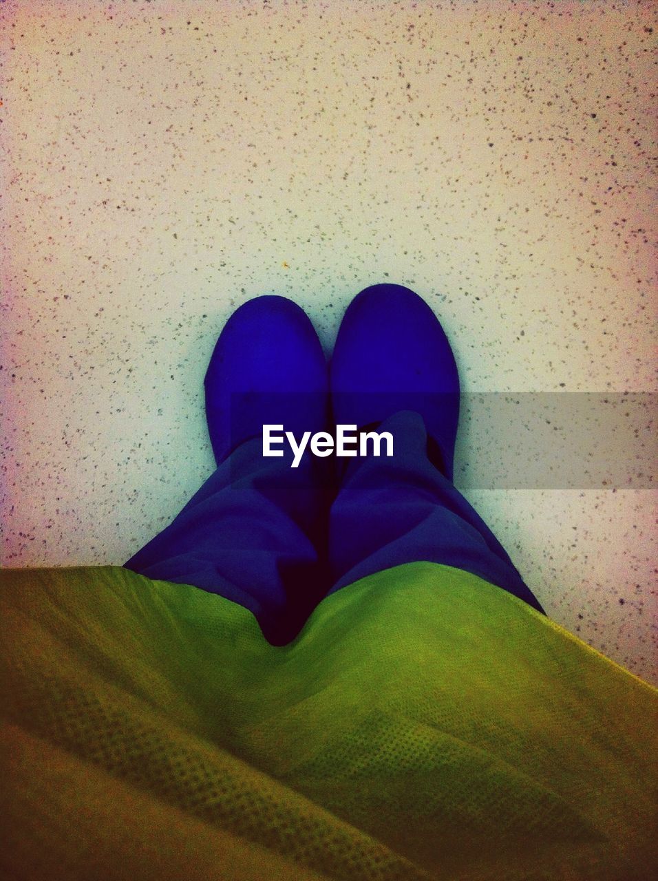 LOW SECTION OF WOMAN STANDING ON TILED FLOOR