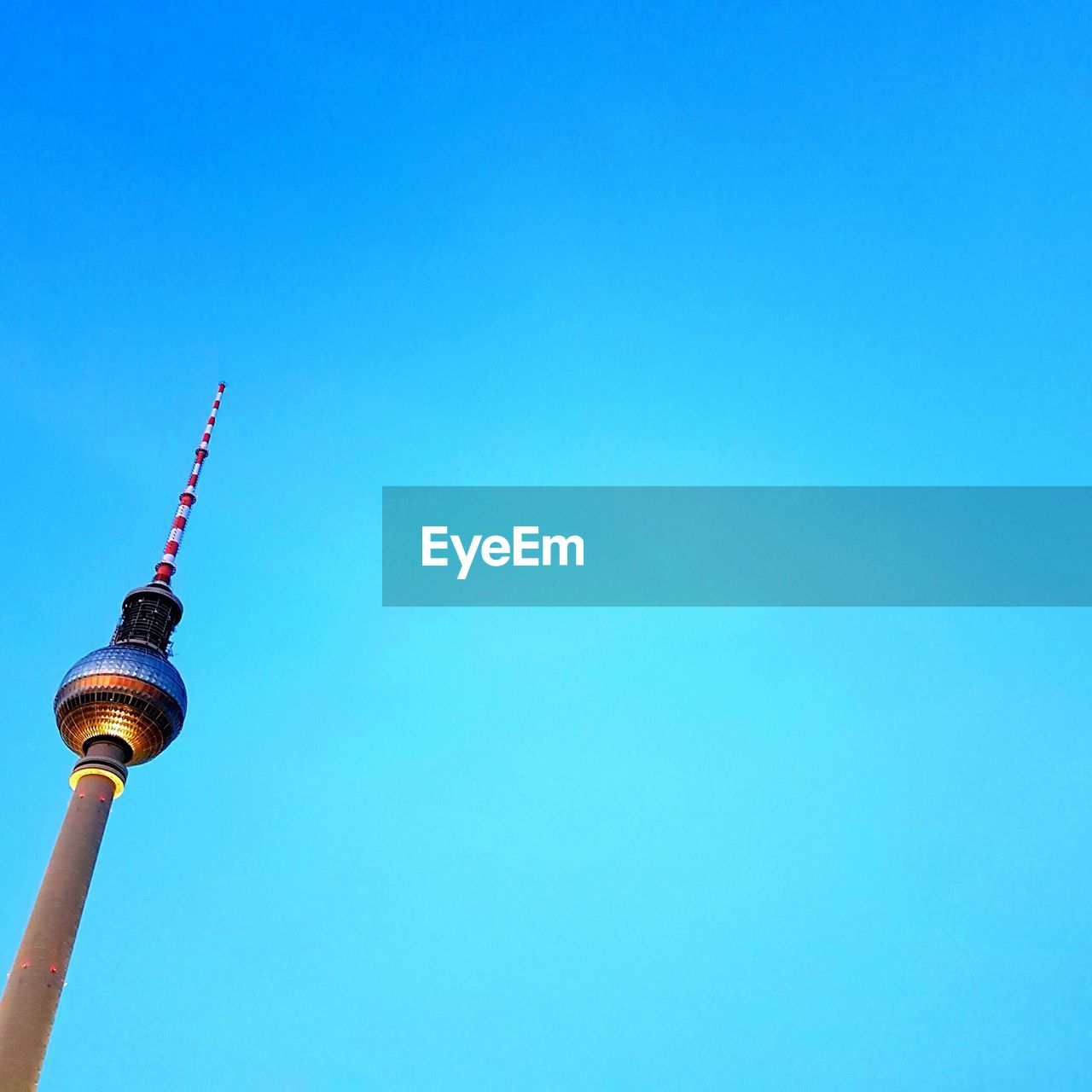 Low angle view of fernsehturm against clear blue sky