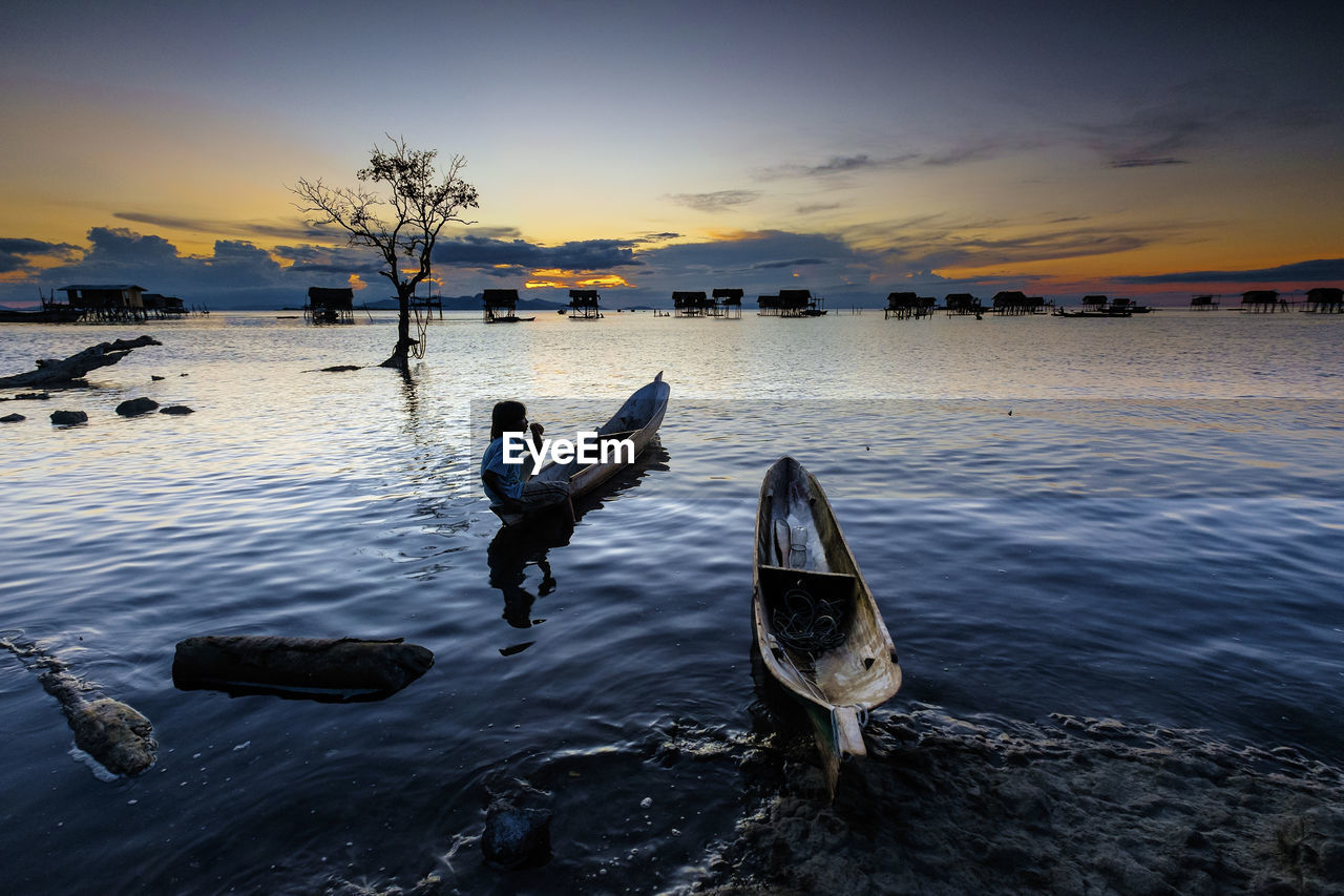 SCENIC VIEW OF SUNSET OVER SEA