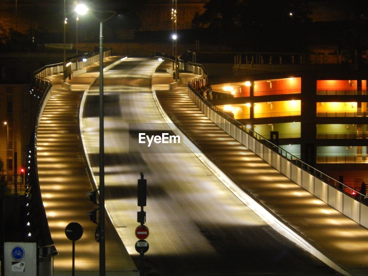 ILLUMINATED WALKWAY AT NIGHT