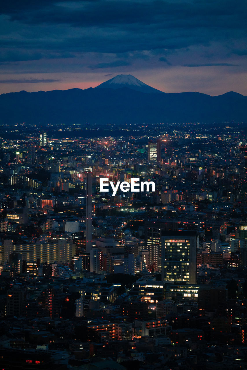 High angle view of night time tokyo with mt fuji in the background