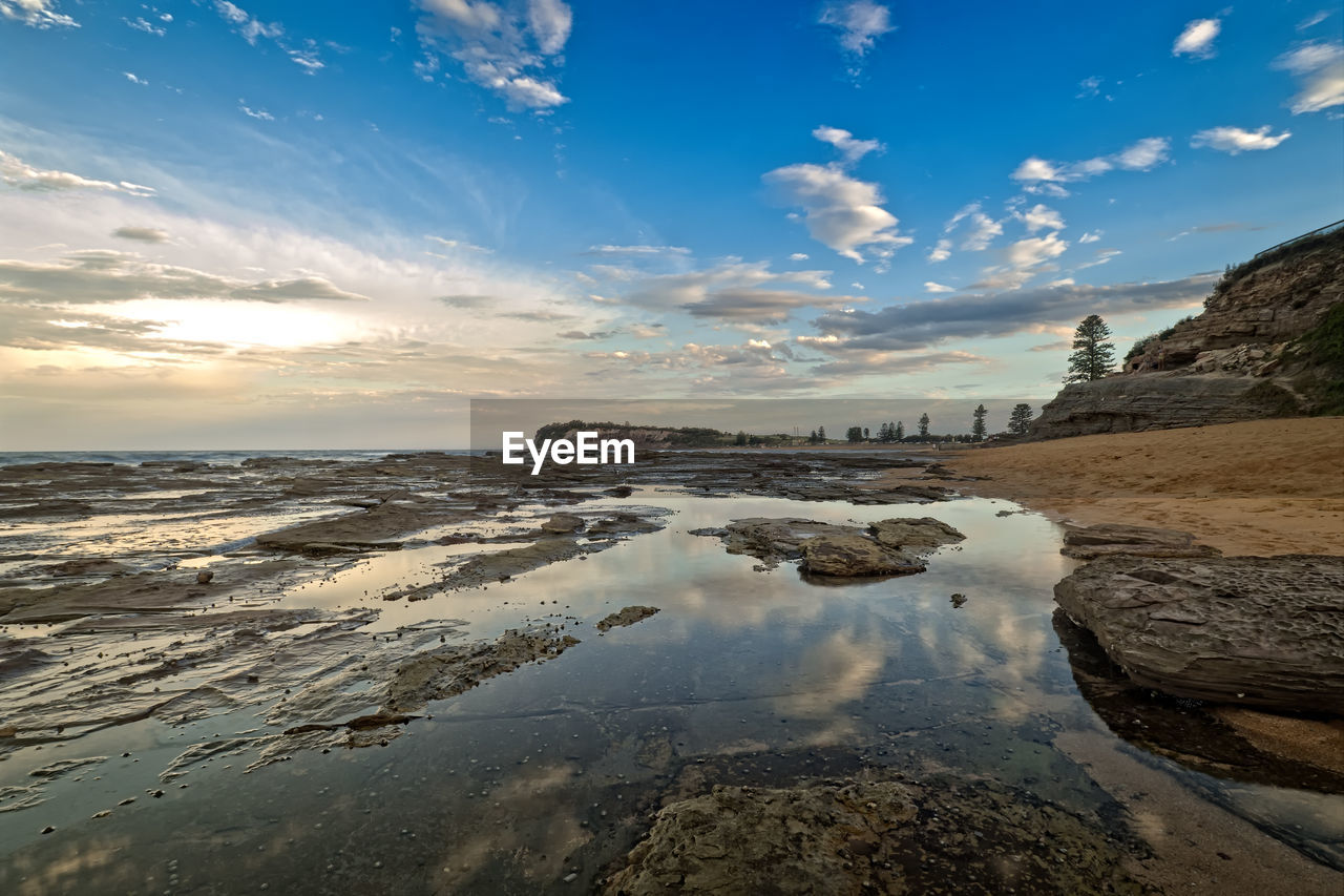 View of beach against cloudy sky