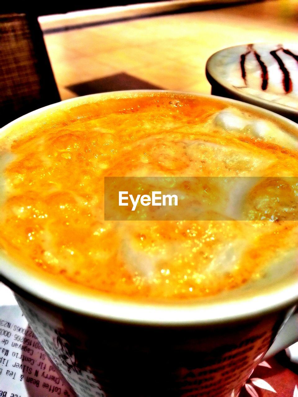 CLOSE-UP OF COFFEE CUP ON TABLE