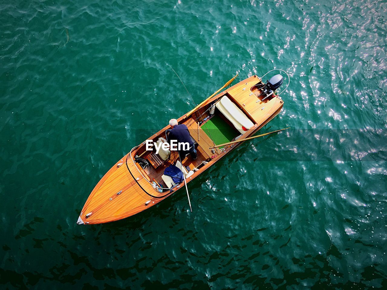 Directly above view of man on motorboat over lake