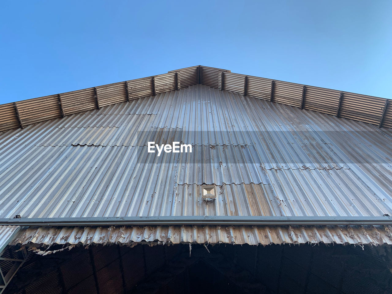 Low angle view of building against clear blue sky