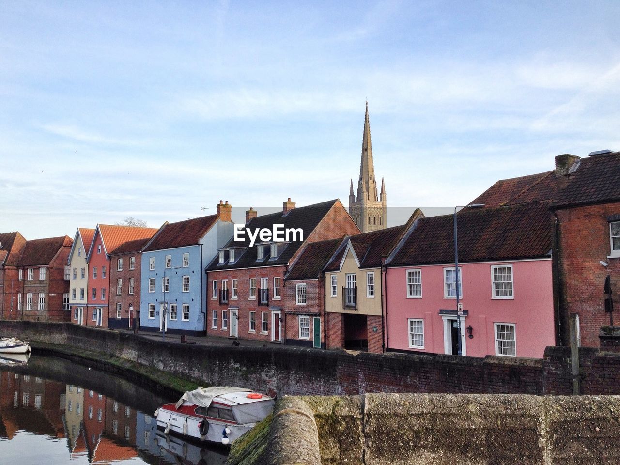 Buildings and cathedral by canal in city