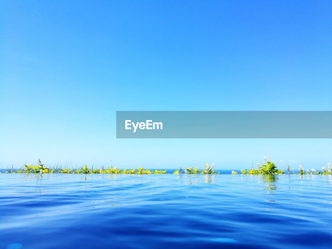 Scenic view of sea against clear blue sky