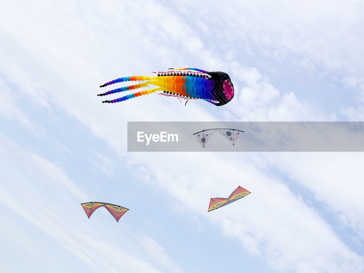 LOW ANGLE VIEW OF KITES FLYING IN SKY